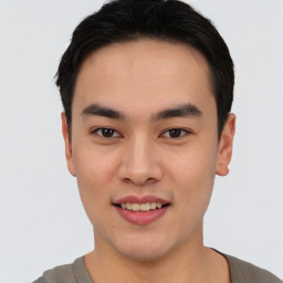 Joyful asian young-adult male with short  black hair and brown eyes