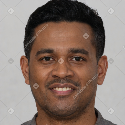 Joyful latino young-adult male with short  black hair and brown eyes