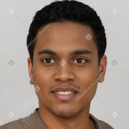 Joyful black young-adult male with short  black hair and brown eyes