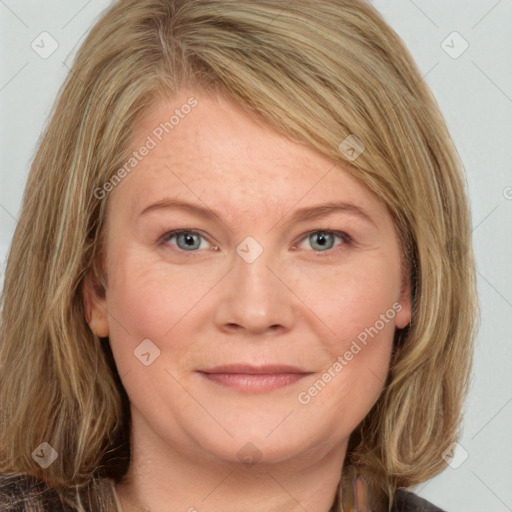 Joyful white adult female with medium  brown hair and blue eyes