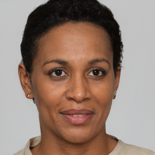 Joyful black adult female with short  brown hair and brown eyes