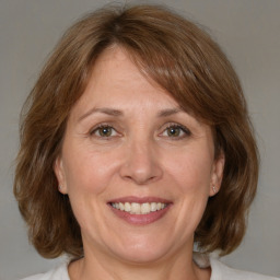 Joyful white adult female with medium  brown hair and brown eyes