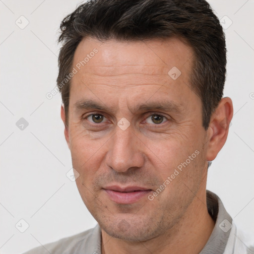 Joyful white adult male with short  brown hair and brown eyes