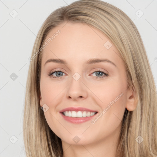 Joyful white young-adult female with long  brown hair and blue eyes