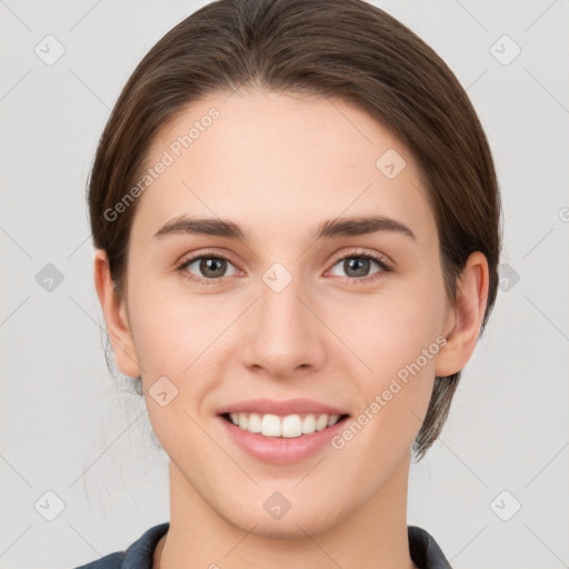 Joyful white young-adult female with medium  brown hair and grey eyes