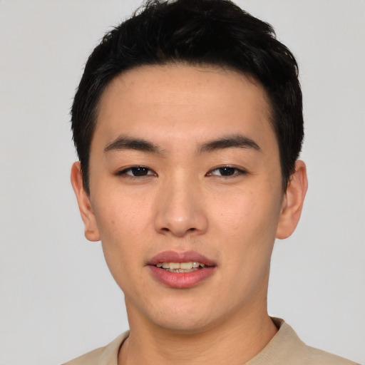 Joyful asian young-adult male with short  black hair and brown eyes