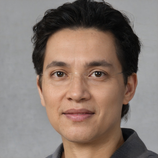 Joyful white adult male with short  black hair and brown eyes
