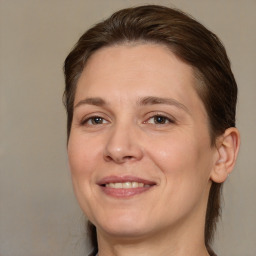 Joyful white adult female with medium  brown hair and brown eyes