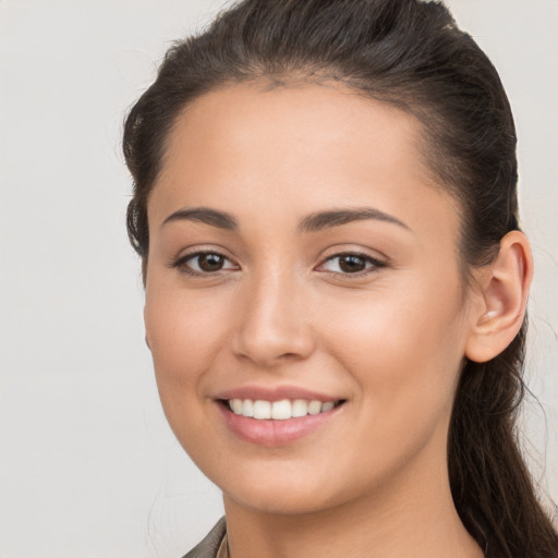 Joyful white young-adult female with long  brown hair and brown eyes