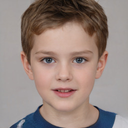 Joyful white child male with short  brown hair and grey eyes