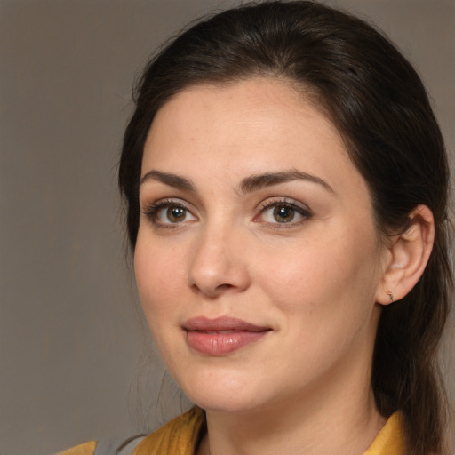 Joyful white young-adult female with medium  brown hair and brown eyes