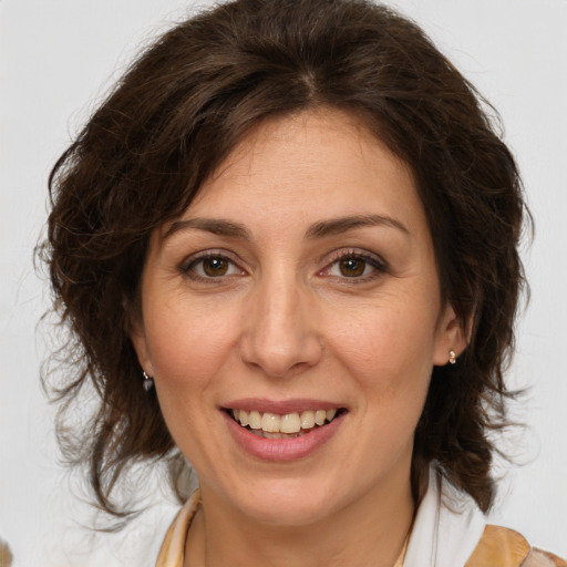 Joyful white adult female with medium  brown hair and brown eyes