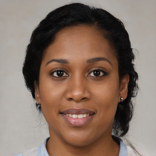 Joyful black young-adult female with medium  black hair and brown eyes