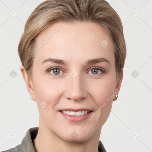 Joyful white young-adult female with short  brown hair and grey eyes