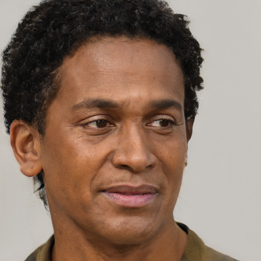 Joyful black adult male with short  brown hair and brown eyes