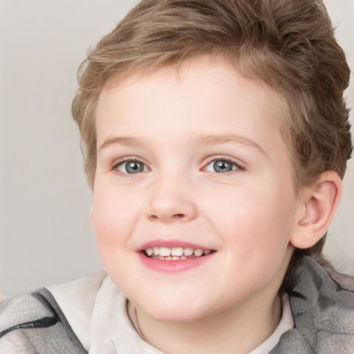 Joyful white child female with short  brown hair and blue eyes