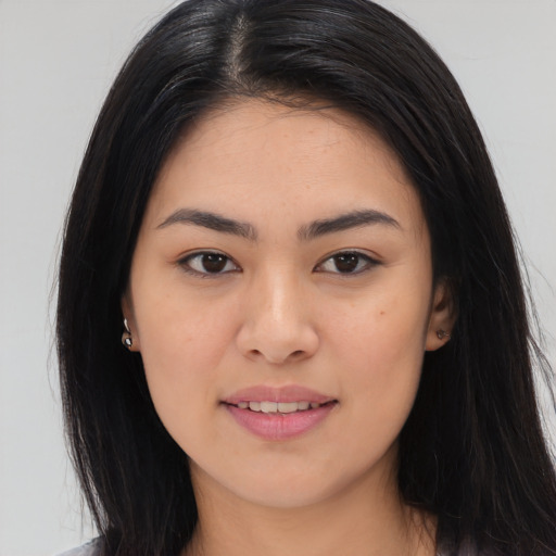 Joyful asian young-adult female with long  brown hair and brown eyes