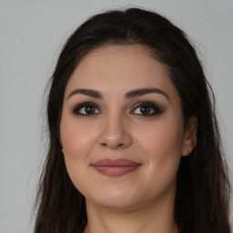 Joyful white young-adult female with long  brown hair and brown eyes