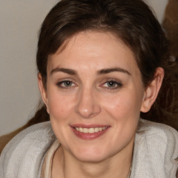 Joyful white adult female with medium  brown hair and brown eyes