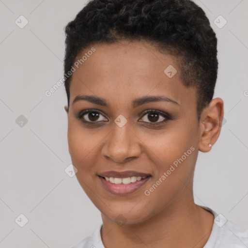 Joyful black young-adult female with short  black hair and brown eyes