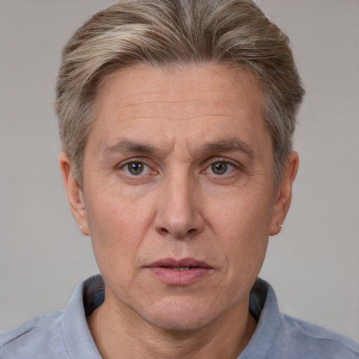 Joyful white adult male with short  brown hair and grey eyes