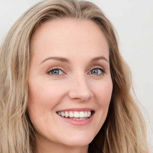 Joyful white young-adult female with long  brown hair and blue eyes