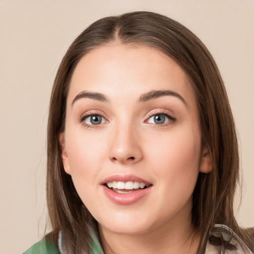 Joyful white young-adult female with long  brown hair and green eyes