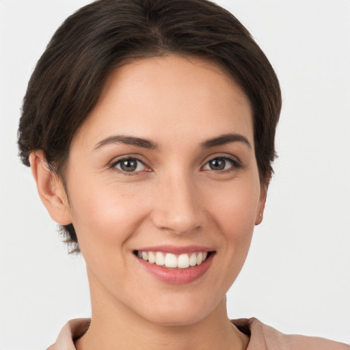 Joyful white young-adult female with short  brown hair and brown eyes