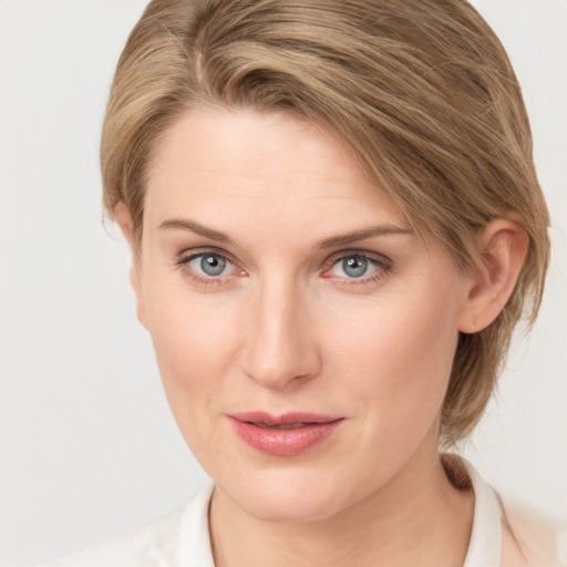 Joyful white young-adult female with medium  brown hair and blue eyes