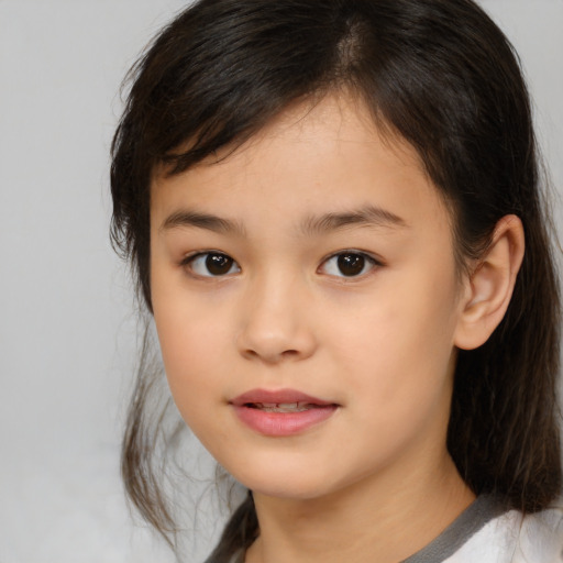 Joyful asian child female with medium  brown hair and brown eyes