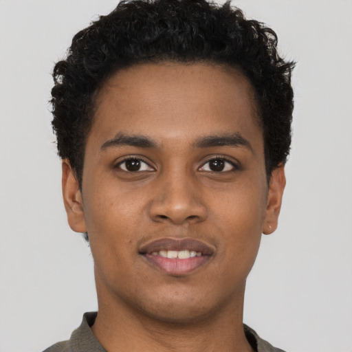 Joyful black young-adult male with short  brown hair and brown eyes