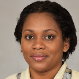 Joyful black adult female with medium  brown hair and brown eyes