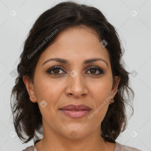 Joyful latino adult female with medium  brown hair and brown eyes