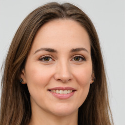 Joyful white young-adult female with long  brown hair and green eyes