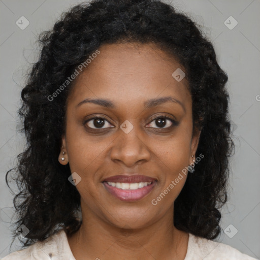 Joyful black young-adult female with long  brown hair and brown eyes