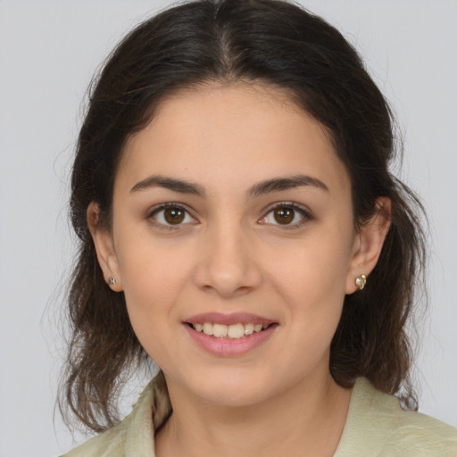 Joyful white young-adult female with medium  brown hair and brown eyes