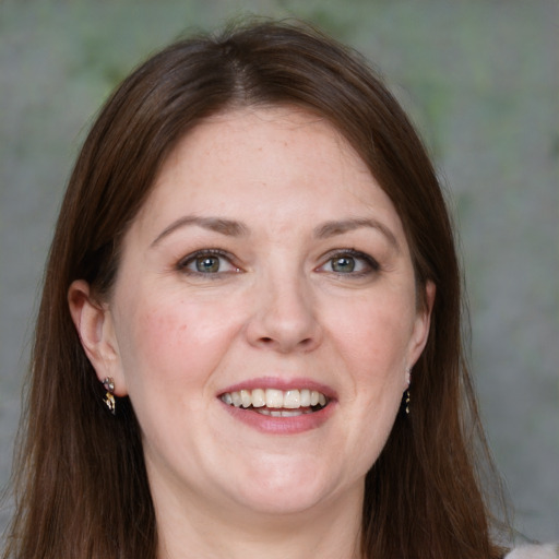 Joyful white adult female with medium  brown hair and grey eyes