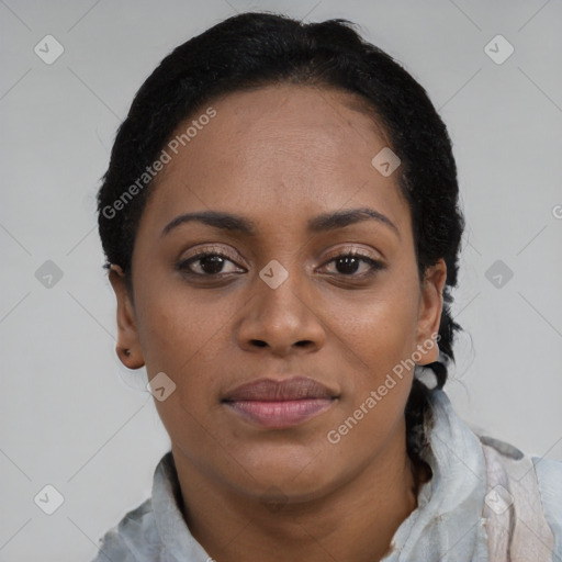 Joyful black young-adult female with short  black hair and brown eyes