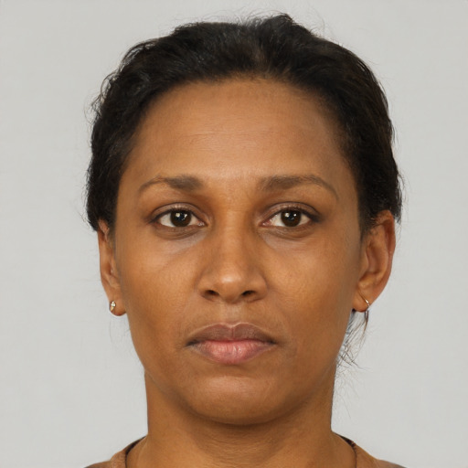 Neutral latino adult female with short  brown hair and brown eyes