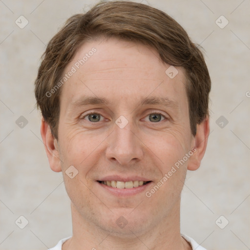 Joyful white adult male with short  brown hair and grey eyes