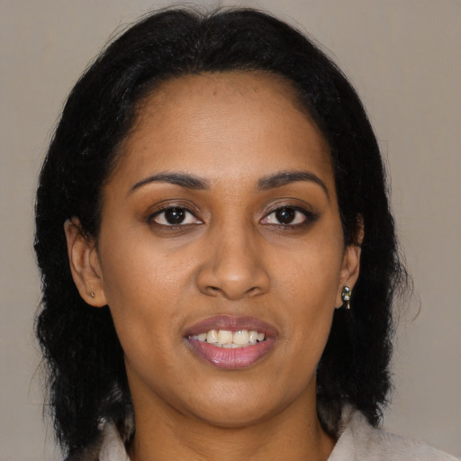 Joyful black young-adult female with medium  black hair and brown eyes