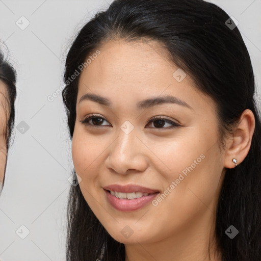 Joyful asian young-adult female with long  brown hair and brown eyes