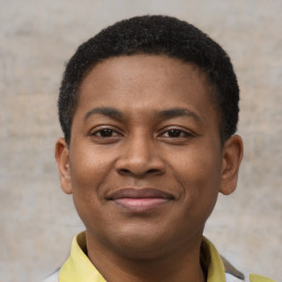 Joyful latino young-adult male with short  brown hair and brown eyes