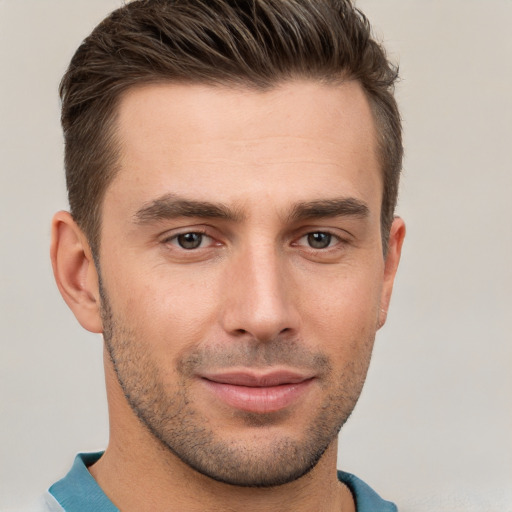 Joyful white young-adult male with short  brown hair and brown eyes