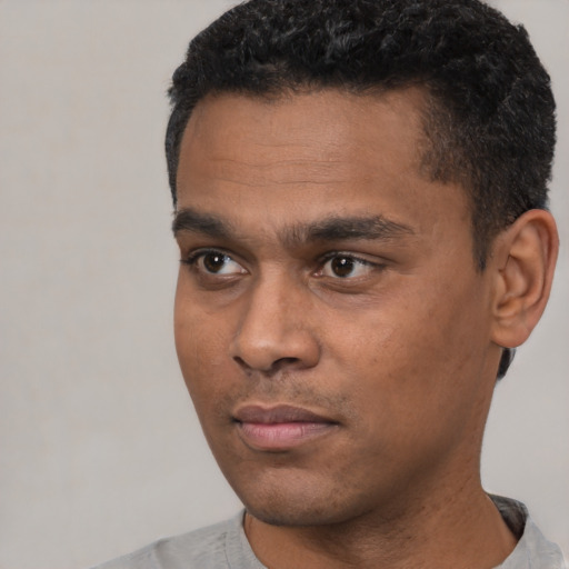 Neutral black young-adult male with short  black hair and brown eyes