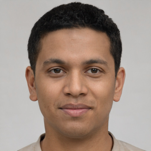 Joyful latino young-adult male with short  black hair and brown eyes