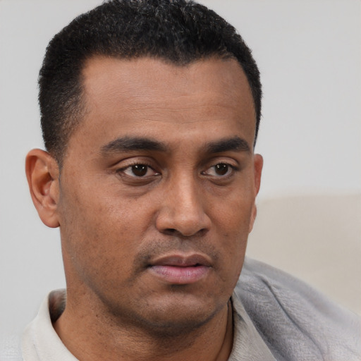 Neutral latino young-adult male with short  brown hair and brown eyes