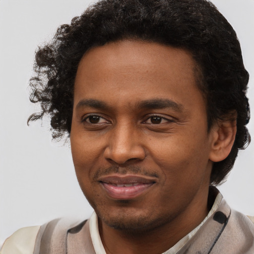 Joyful black young-adult male with short  brown hair and brown eyes