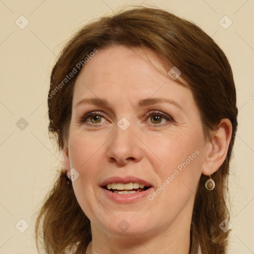 Joyful white adult female with medium  brown hair and green eyes