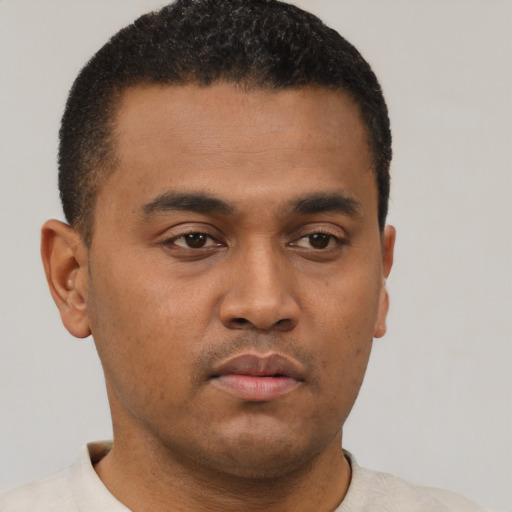 Neutral latino young-adult male with short  brown hair and brown eyes